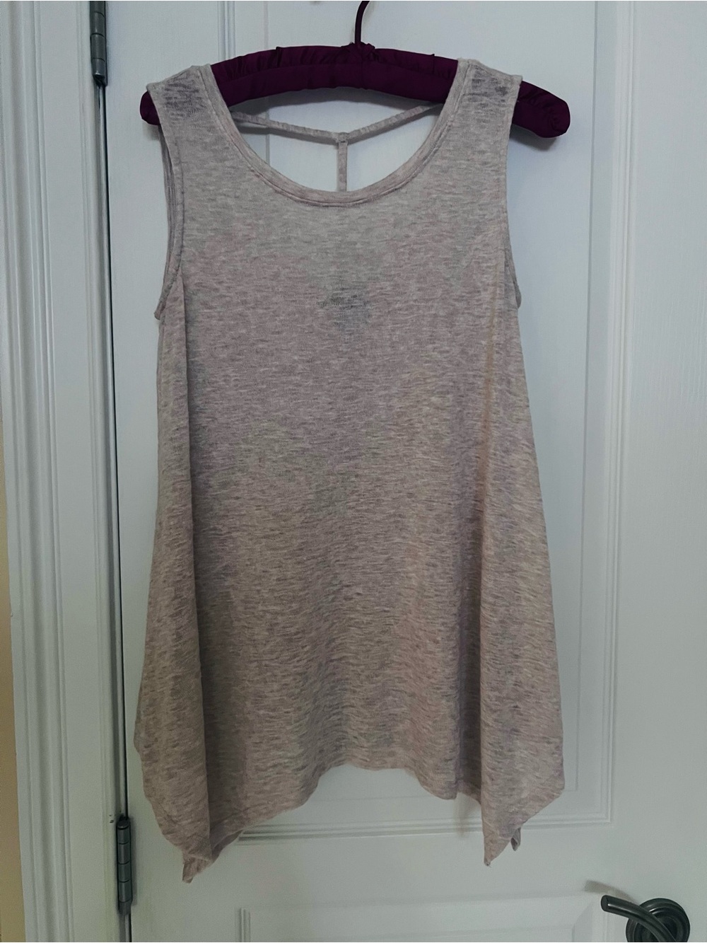 Women’s heather oatmeal Sleeveless Swing Tank Top with cut-out back strapping.